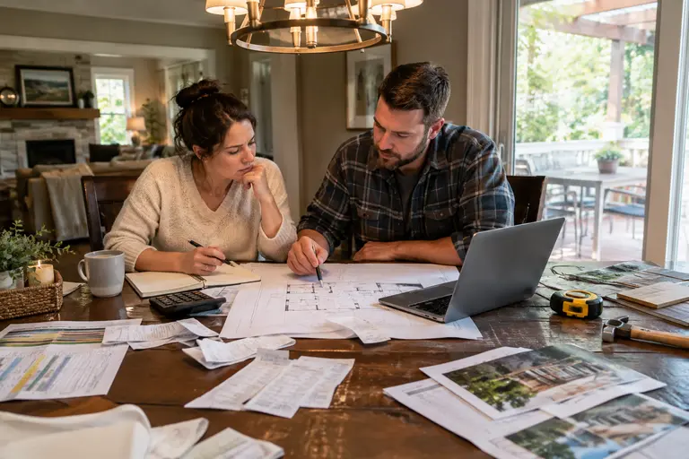 Printed contractor bid with calculator and home project checklist
